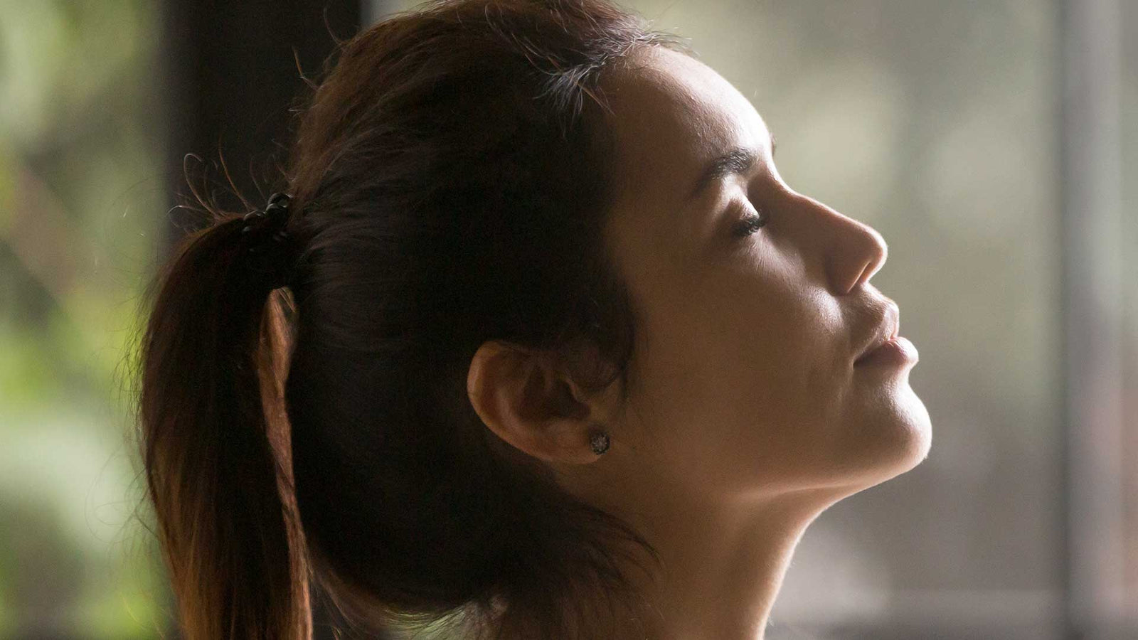 Woman outdoors with eyes closed