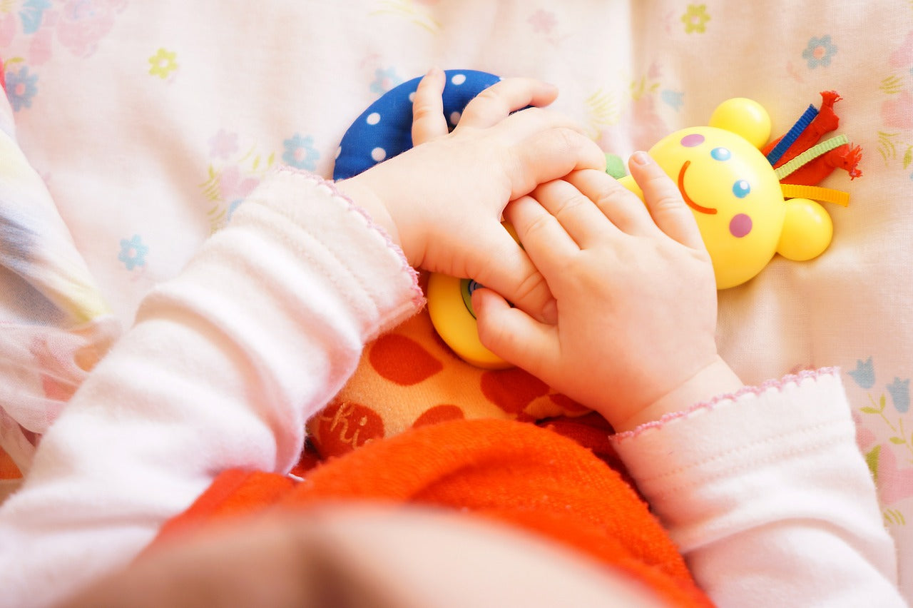 Baby holding teething toys