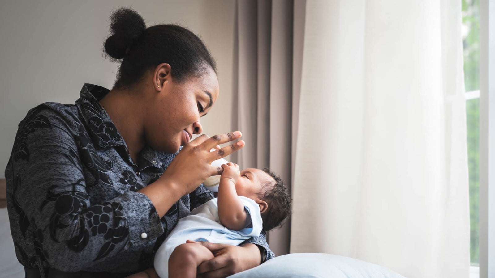 Mother bottle feeding her baby