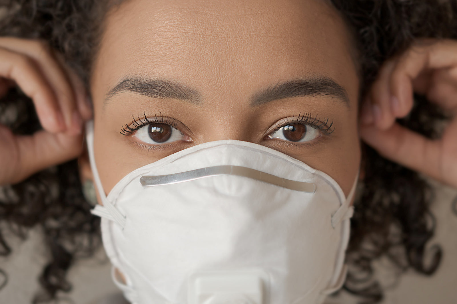 Close up of woman wearing white face mask