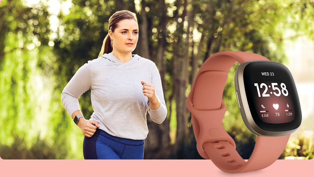 Woman running and coral Fitbit Versa 3