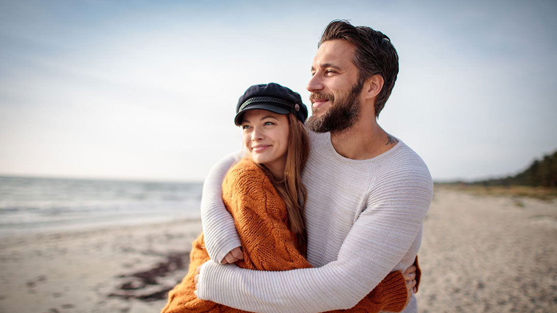 Young man and woman hugging on a beach