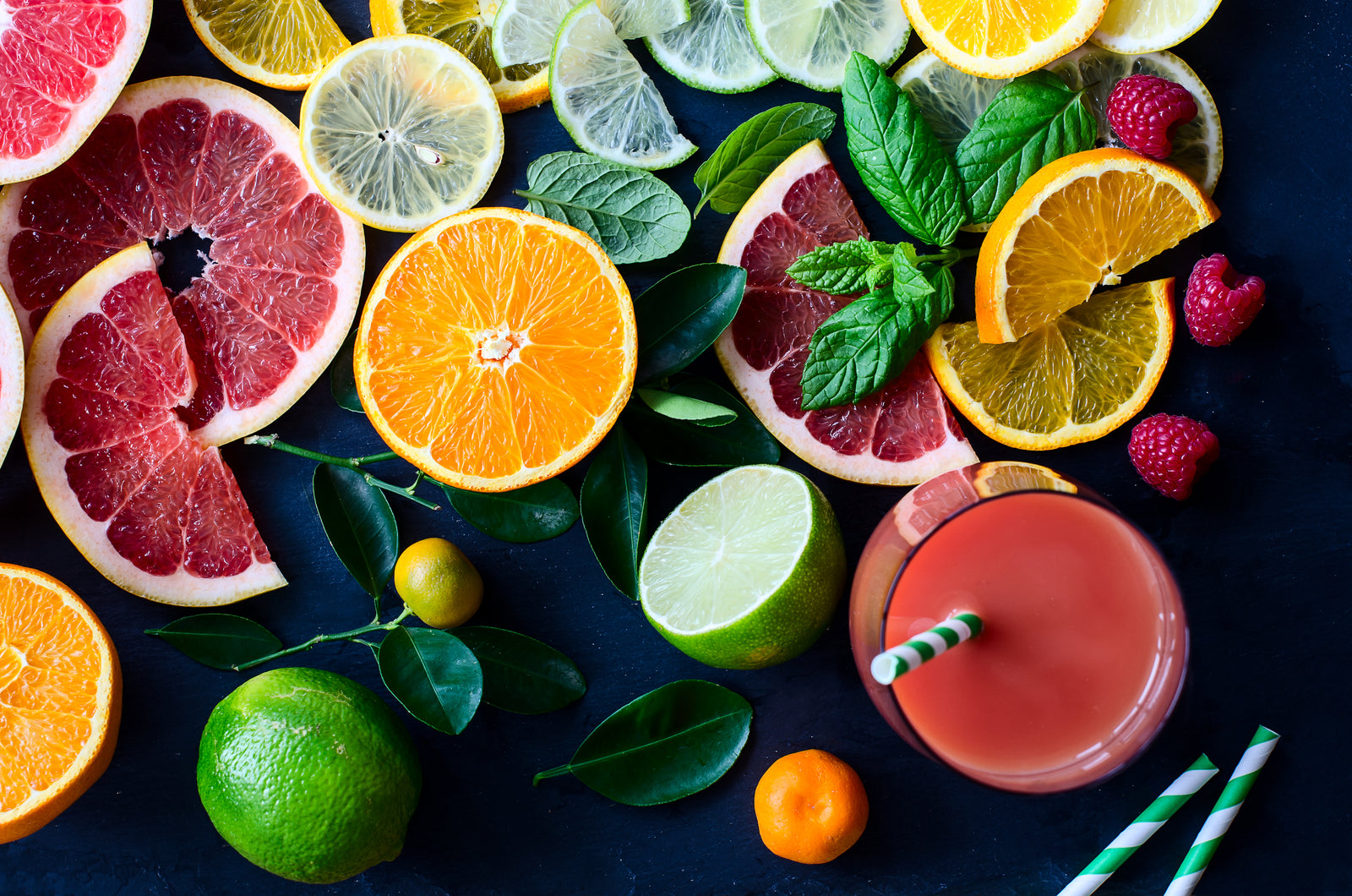 Slices of bright citrus fruit on a black background