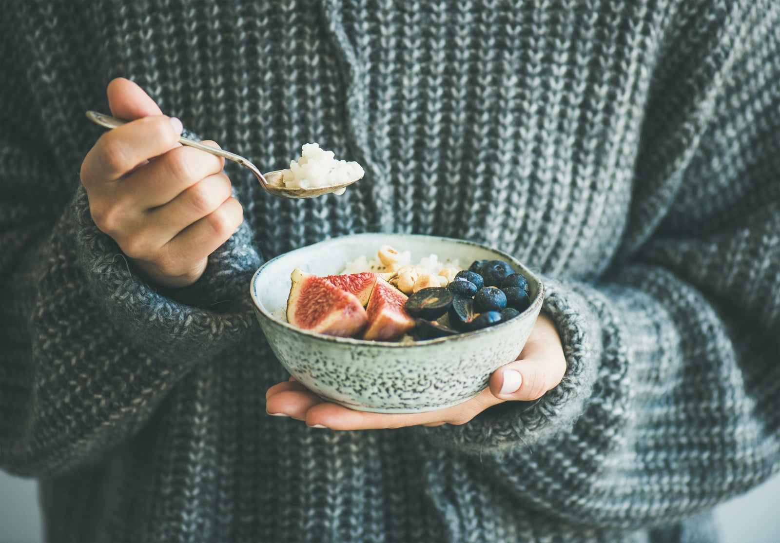 Woman holding a bowl of porridge