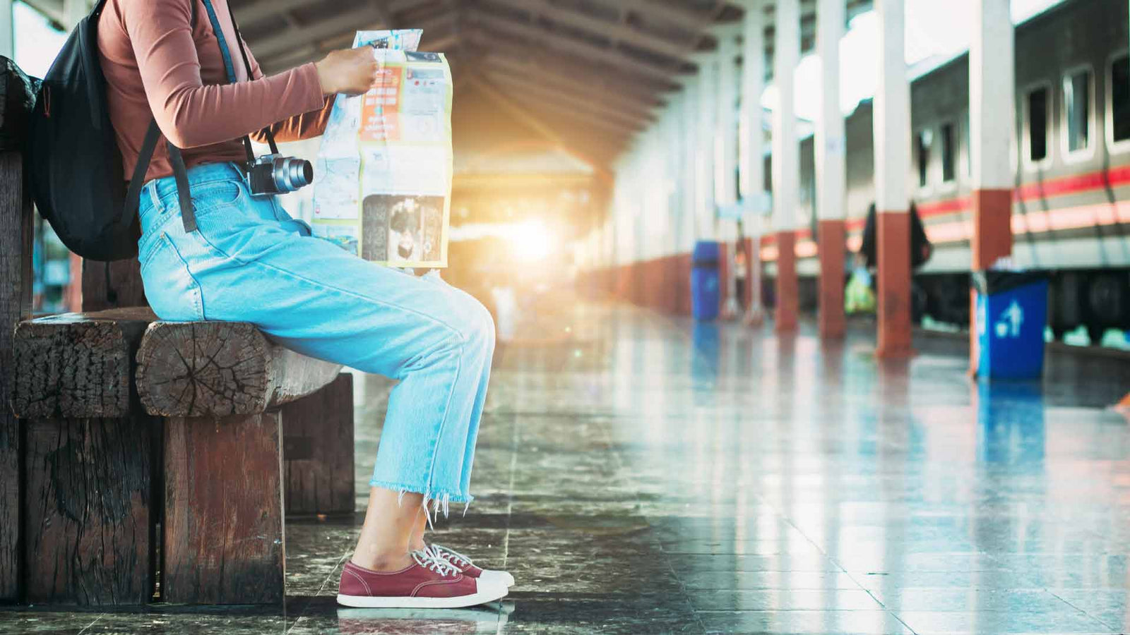 Woman at train station reading a map