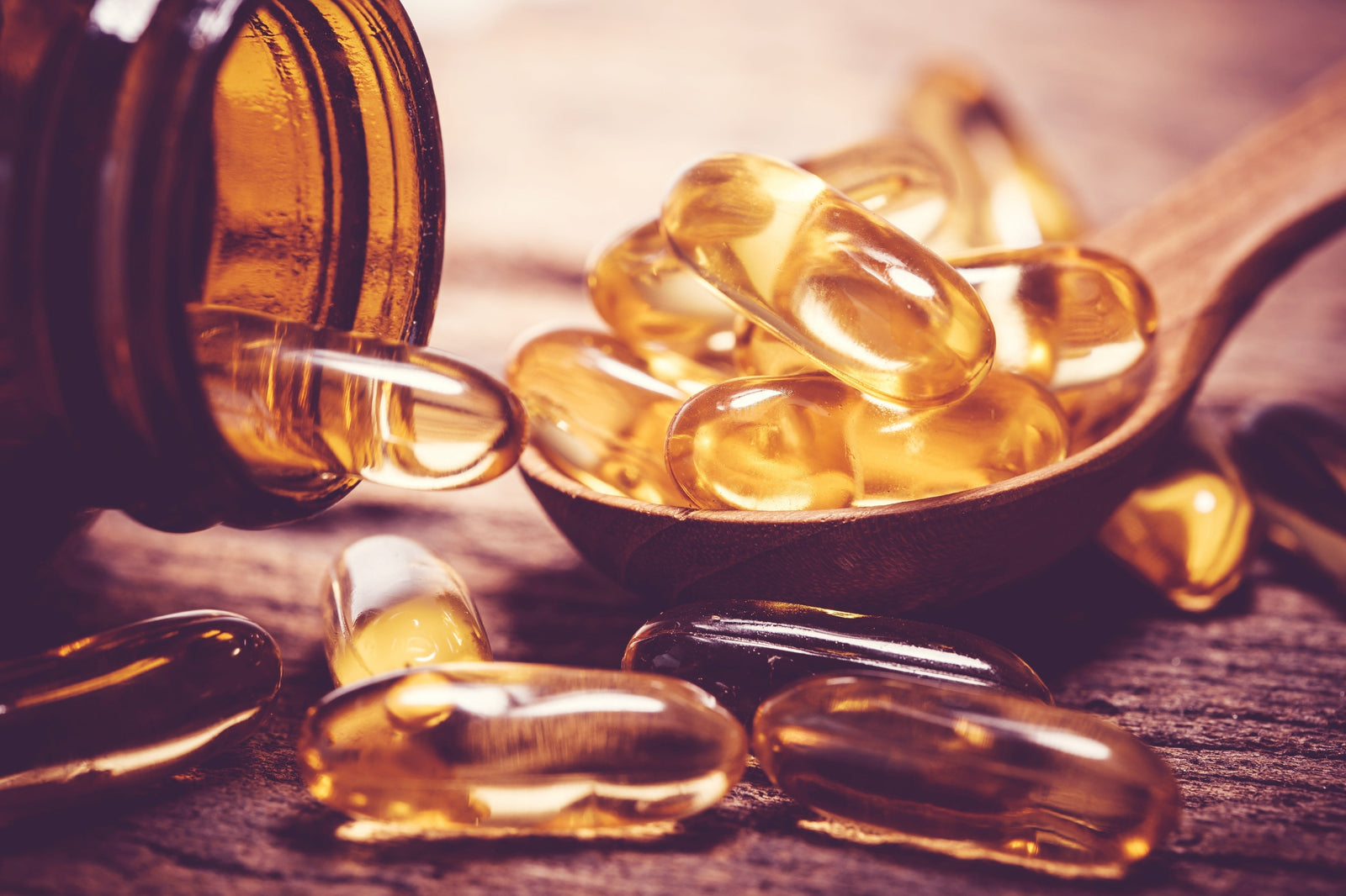 Vitamin oil capsules piled on a spoon