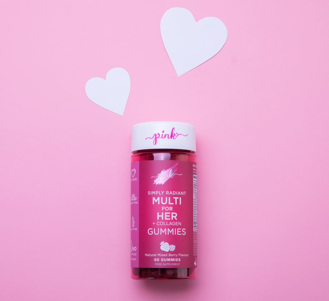 Pink multivitamins for her with hearts on a pink background