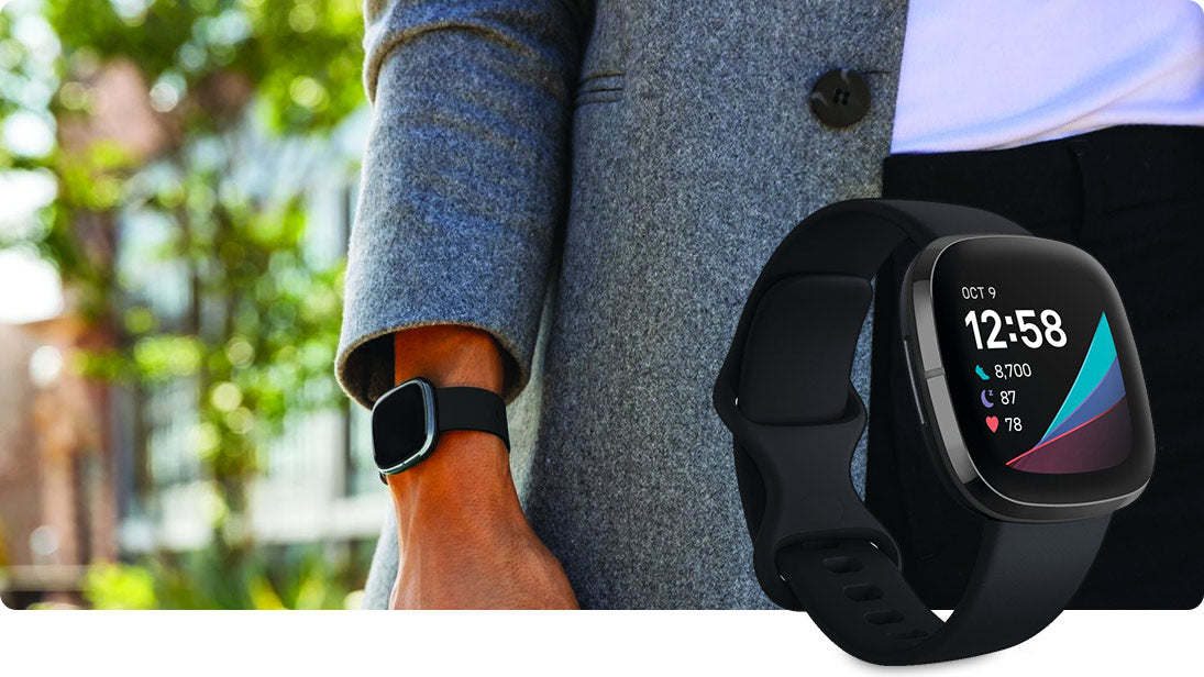 Black Fitbit sense and man's wrist