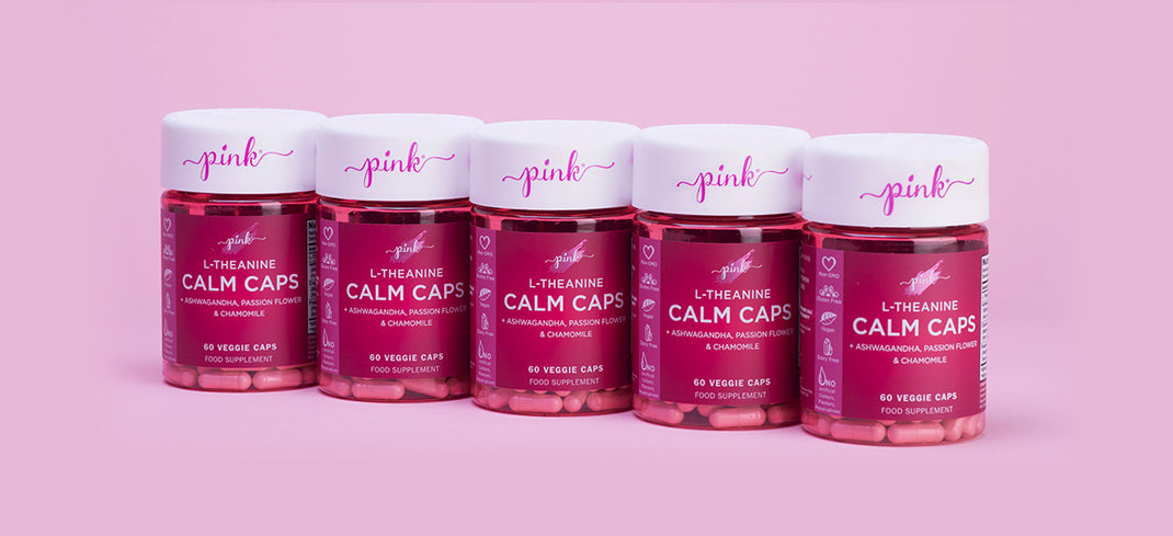 Pink calm caps vitamins in a line