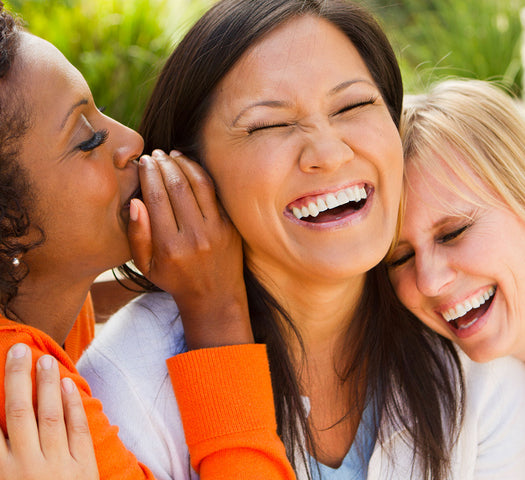 Three ladies laughing outside